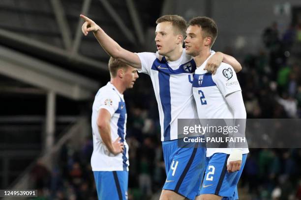 Finland's defender Robert Ivanov and Finland's defender Leo Vaisanen celebrate on the final whistle of the UEFA Euro 2024 group H qualification...