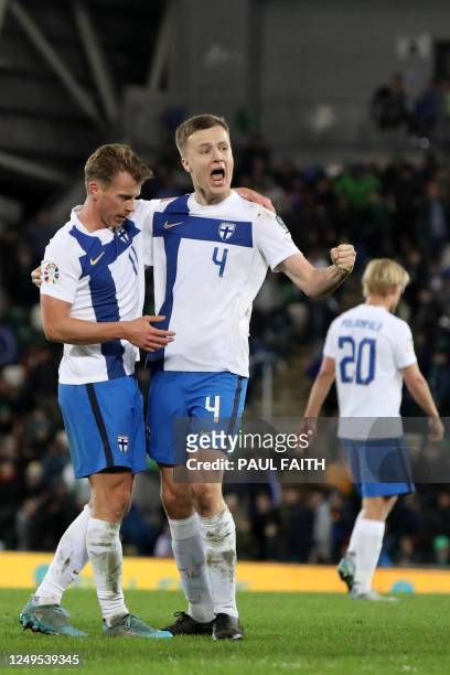 Finland's midfielder Rasmus Schuller and Finland's defender Robert Ivanov celebrate on the final whistle of the UEFA Euro 2024 group H qualification...