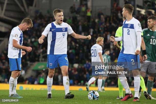 Finland's defender Robert Ivanov celebrates with teammates on the final whistle of the UEFA Euro 2024 group H qualification football match between...