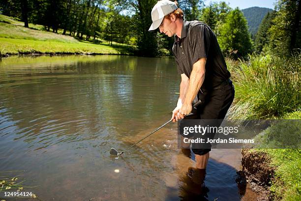 golfer in the water hazard. - golf ball in water stock pictures, royalty-free photos & images