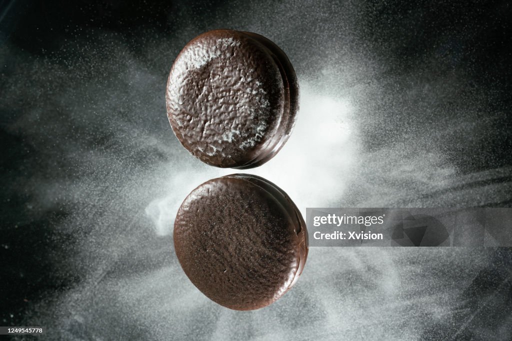 Chocolate pie flying in mid air view from above sync in high speed