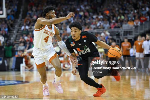 Miami Hurricanes guard Nijel Pack drives against Texas Longhorns guard Tyrese Hunter during the Elite Eight round of the 2023 NCAA Men's Basketball...