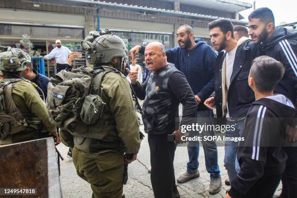 Palestinians confront Israeli soldiers, after a shooting attack on two Israeli soldiers, in the town of Hawara, south of Nablus, in the occupied West...