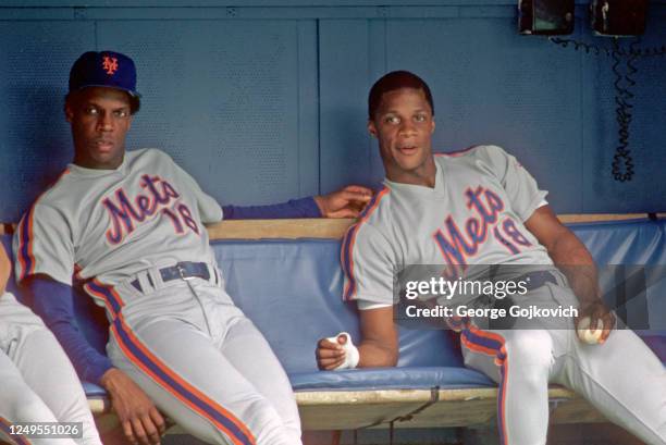 Dwight Gooden and Darryl Strawberry of the New York Mets look on from the dugout during a Major League Baseball game against the Pittsburgh Pirates...