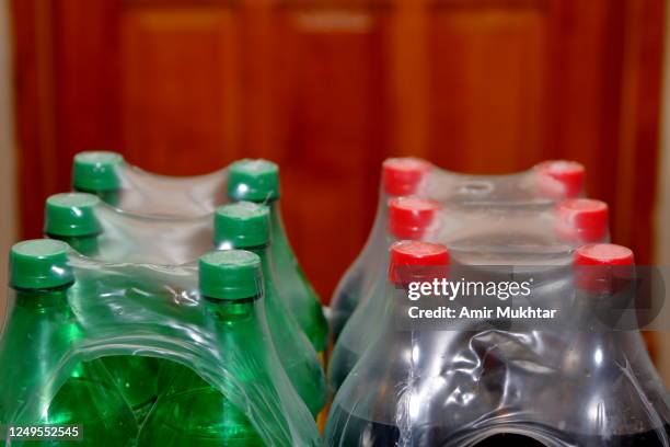 cold drink bottles packed and wrapped in plastic - cola bottle stock pictures, royalty-free photos & images