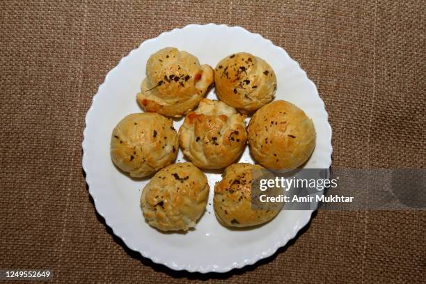 baked cheese balls in white plate from directly above. - cheese ball stock pictures, royalty-free photos & images