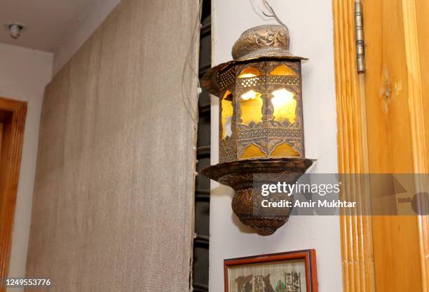 lit brass lamp hanging or fixed on wall. - antique lamp stock pictures, royalty-free photos & images