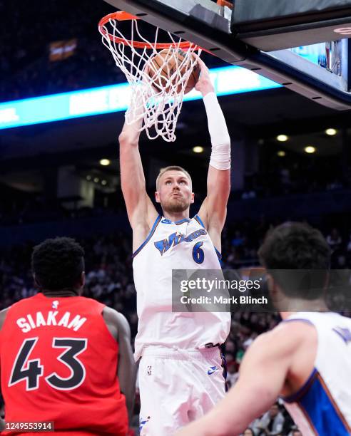 Kristaps Porzingis of the Washington Wizards dunks against the Toronto Raptors during the second half of their basketball game at the Scotiabank...