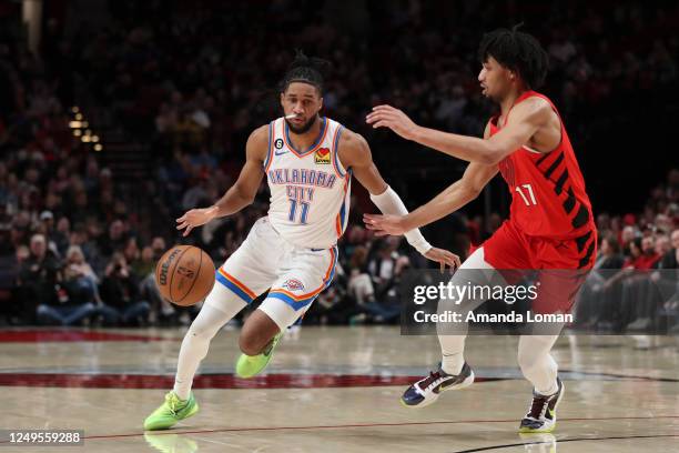 Isaiah Joe of the Oklahoma City Thunder drives up the court as Shaedon Sharpe of the Portland Trail Blazers defends during the third quarter at Moda...