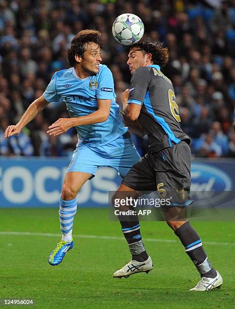 Manchester City's Spanish midfielder David Silva vies with Napoli's Italian defender Salvatore Aronica during the UEFA Champions league group A...