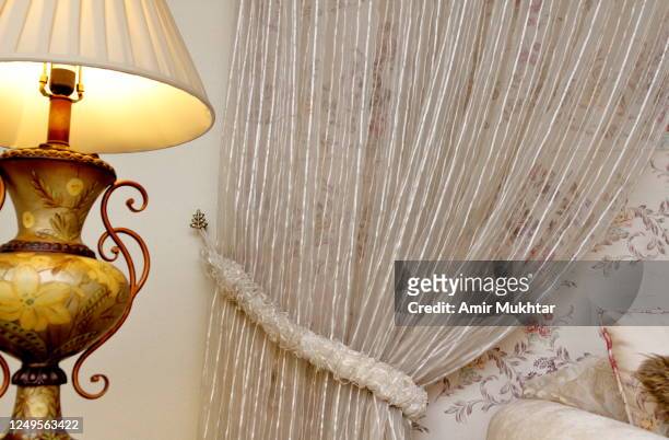 curtain tied with wall and electric lamp lit at side. - punjab pakistan stockfoto's en -beelden