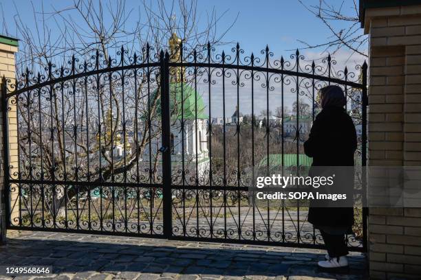 Woman looks through the fence at the Kiev-Pechersk Lavra. Ukraine's Ministry of Culture released a statement on March 10 saying that the National...