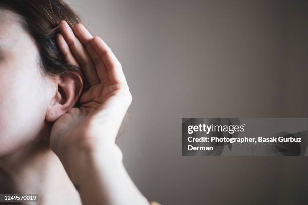 a woman's ear, listening - ears photos et images de collection