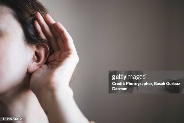 a woman's ear, listening - woman listening ストックフォトと画像