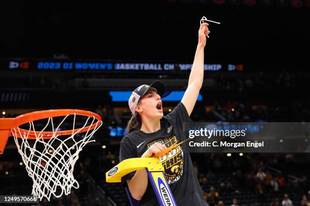 Caitlin Clark of the Iowa Hawkeyes cuts down the net after defeating the Louisville Cardinals during the Elite Eight round of the 2023 NCAA Women's...