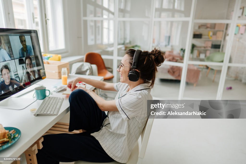 Smiling woman having a video call with her friends