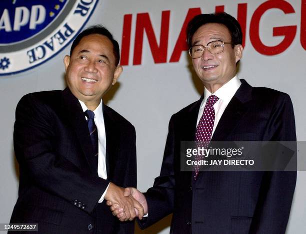 Philippines Speaker of the House of Represenatives Jose de Venecia shakes hands with Wu Bangguo , chairman of the standing committee of the National...
