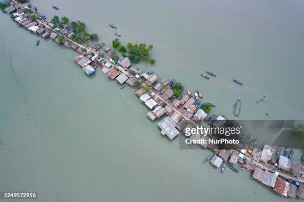 An aerial view of Kalabogi village is being taken during the high tide in Khulna, Bangladesh on March 10, 2023. The houses are seen almost damaged...