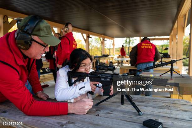 Greeley, PA Visitors fire an AR-15 style gun from Kahr Firearms Group at a firing range during the 3rd annual Rod of Iron Freedom Festival an open...