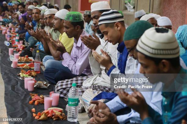 Muslim devotees pray before breaking their fast at the Nakhoda Mosque during the holy month of Ramadan.