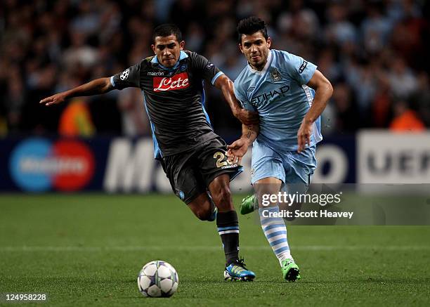 Sergio Aguero of Manchester City competes with Walter Gargano of Napoli during the UEFA Champions League Group A match between Manchester City and...