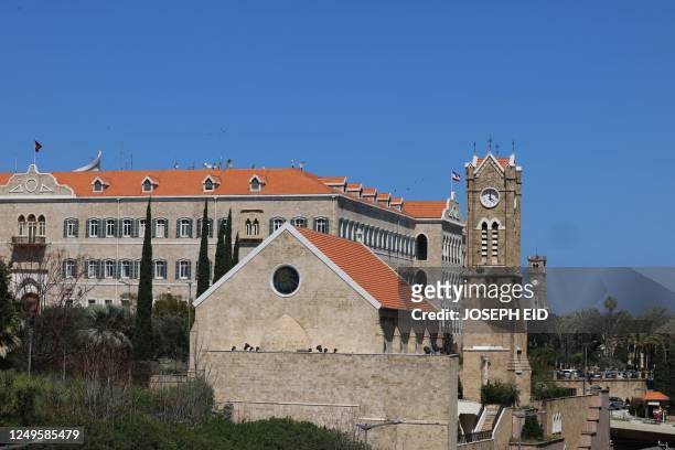 Church's clock tower next to the governmental palace in Beirut indicates the new summer time on March 27, 2023. - Lebanon is divided between two time...