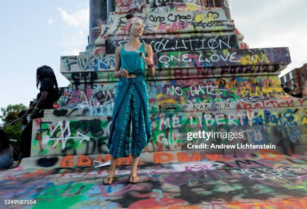 Black Lives Matter activists occupy the traffic circle underneath the statue of Confederate General Robert Lee, now covered in graffiti, on June 13,...