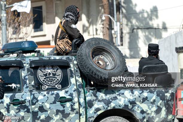 Taliban security personnel sit in a vehicle near the site of a suicide attack in Kabul on March 27, 2023. - A suicide attack on March 27 not far from...