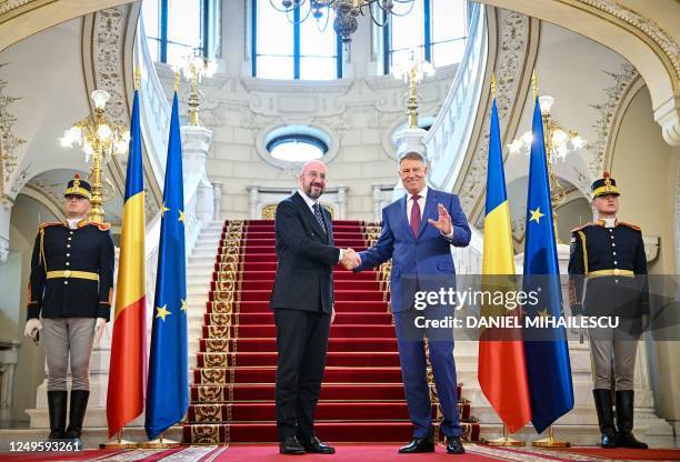 Romanian President Klaus Iohannis shakes hands with the President of the European Council Charles Michel at the presidential Cotroceni Palace in...