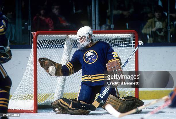 Goalie Tom Barrasso of the Buffalo Sabres makes the glove save during an NHL preseason game against the New York Islanders in October, 1984 at the...
