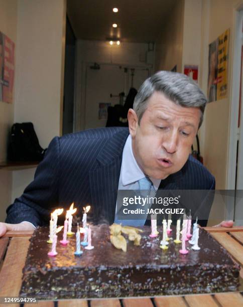 French far-right presidential candidate Philippe de Villiers blows candles as he attends his birthday party at his campaign headquarters, 25 March...