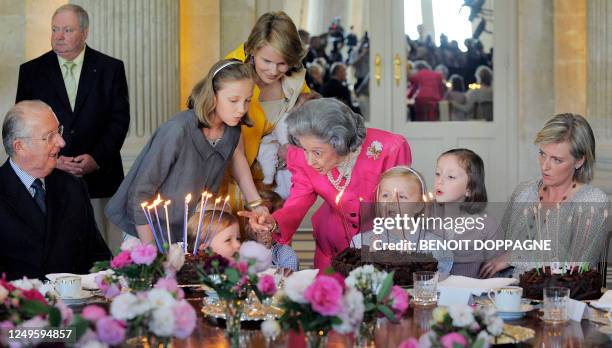 Queen Fabiola of Belgium blows out the candles of her 80th birthday cake, on June 3 in Laeken / Laken Royal castle, with her family, Princess...