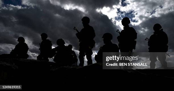 Ukraine Army recruits stand above a trench as they wait to take part in a trench warfare training session with members of New Zealand's armed forces...