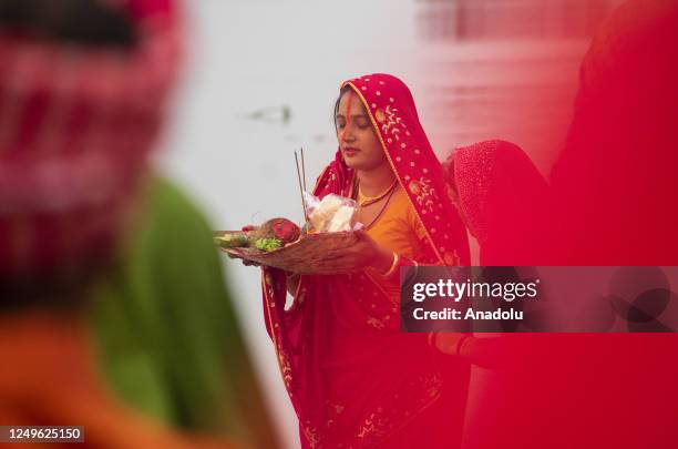 Hindu Chhath devotees perform rituals during 'Kharna Puja' of Chaiti Chhath festival at the bank of Brahmaputra river on March 27, 2023 in Guwahati,...