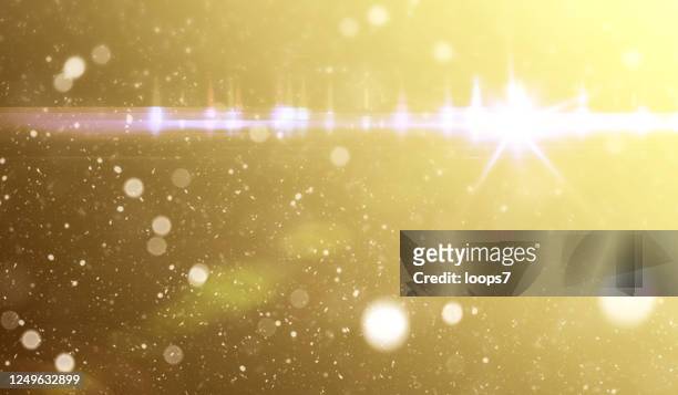 lens flare, bokeh and dust against golden gradient background - anamorphic lens flare stock illustrations