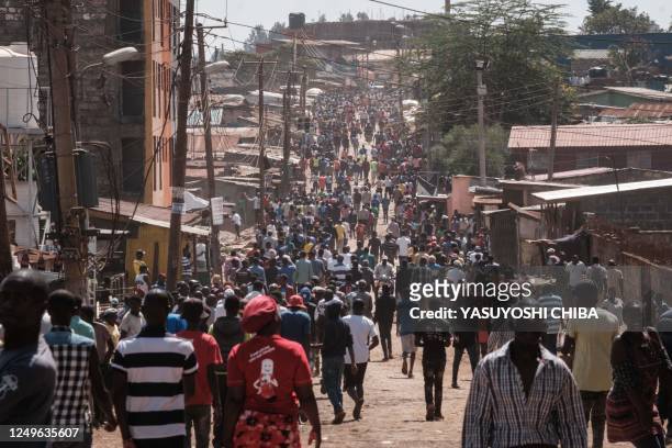People walk on the street to join a rally called by the opposition leader Raila Odinga who claims the last Kenyan presidential election was stolen...