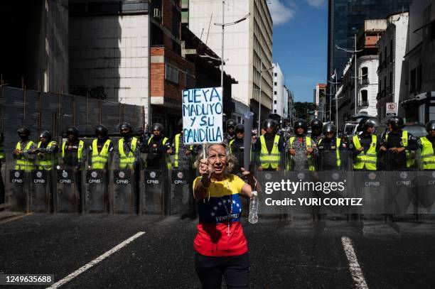 Woman shouts anti-corruption slogans while participating in a demonstration held by health and education workers to demand a leveling of wages in...