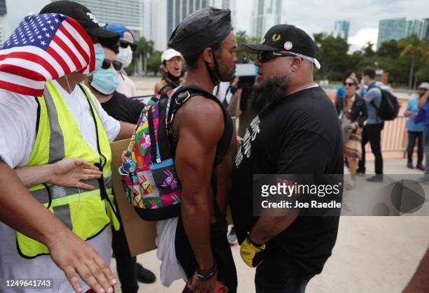 Jonathan Gartrelle , participating in a protest against police brutality, confronts a demonstrator taking part in a counter demonstration advertised...