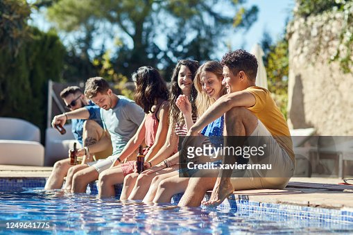 Young Friends Enjoying Beers At Summertime Pool Party High-Res Stock ...