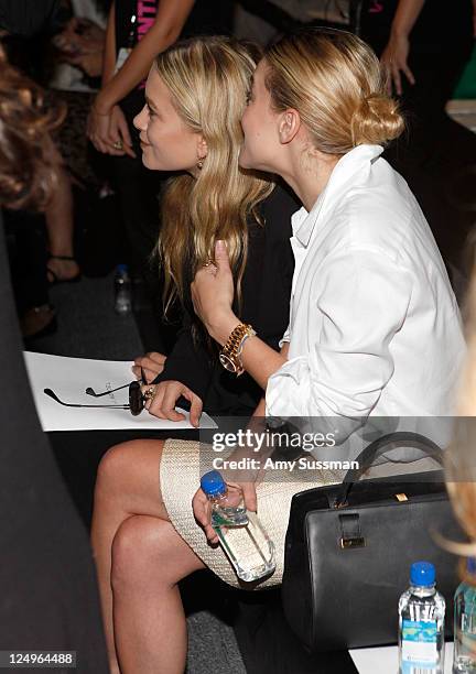 Mary-Kate Olsen and Ashley Olsen pose with FIJI Water at the J. Mendel Spring 2012 show during Mercedes-Benz Fashion Week on September 14, 2011 in...