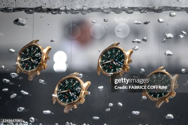 Watches are seen in water at the booth of Swiss watch manufacturer IWC on the opening day of the luxury watch fair 'Watches and Wonders Geneva', on...