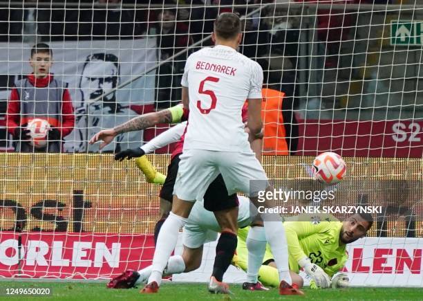 Poland's defender Jan Bednarek and Albania's goalkeeper Thomas Strakosha vie during the UEFA Euro 2024 Group E qualification football match between...