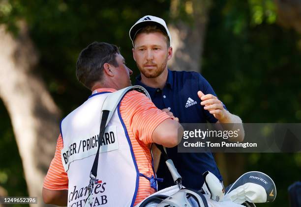 Daniel Berger of the United States celebrates with his caddie on the 17th green after defeating Collin Morikawa of the United States during a playoff...