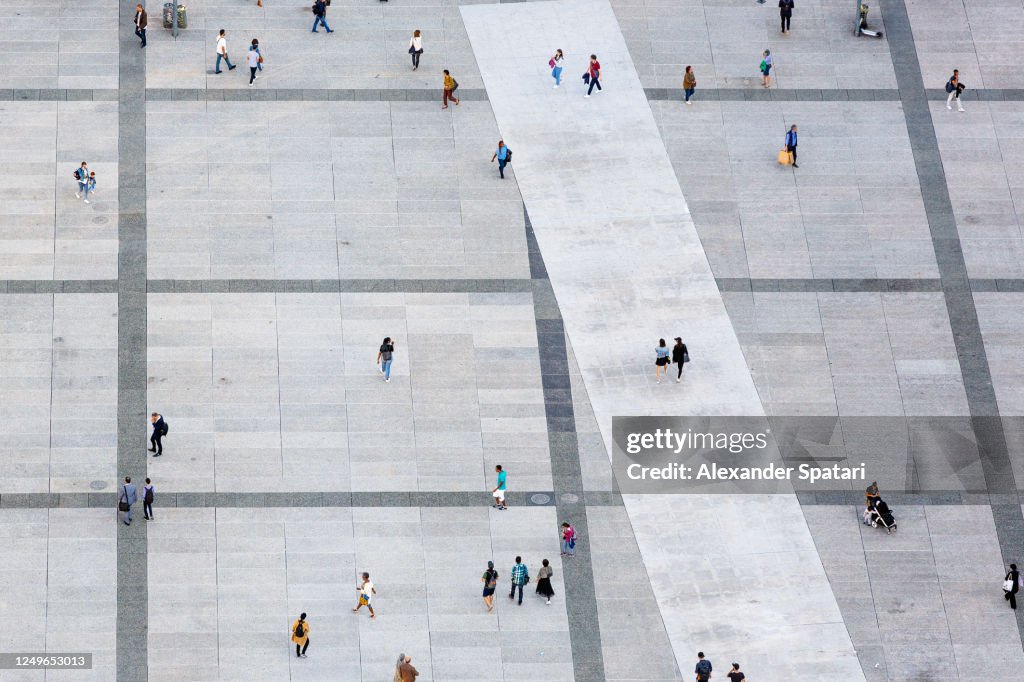 Aerial view of people walking at the city square