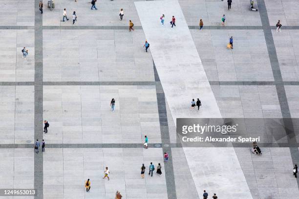 aerial view of people walking at the city square - overhead view stock pictures, royalty-free photos & images