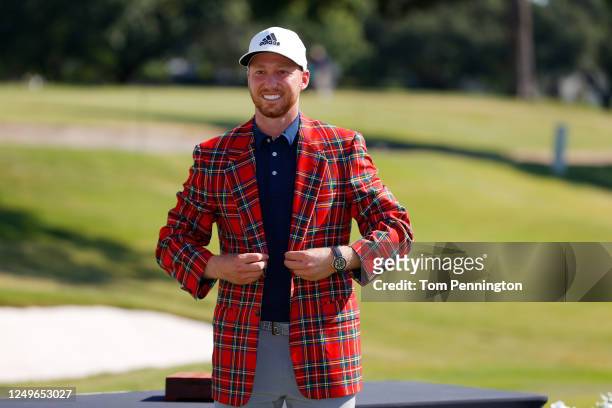 Daniel Berger of the United States puts on the plaid jacket as he celebrates winning after defeating Collin Morikawa of the United States in a...