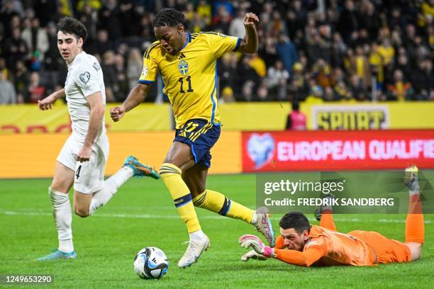 Sweden's forward Anthony Elanga gets past Azerbaijan's goalkeeper Emil Balayev and Azerbaijan's defender Bahlul Mustafazade to score the 5-0 goal...