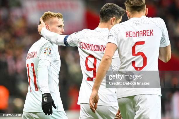 Karol Swiderski of Poland and Robert Lewandowski of Poland celebrates after scoring during the UEFA EURO 2024 qualifying round group E match between...