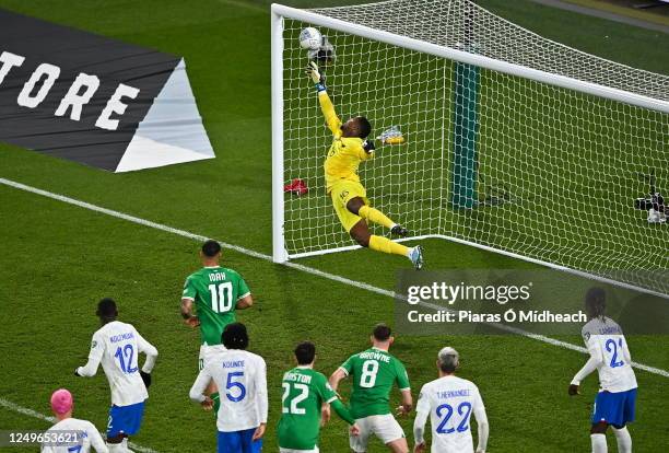 Dublin , Ireland - 27 March 2023; France goalkeeper Mike Maignan saves the header from Nathan Collins of Republic of Ireland during the UEFA EURO...