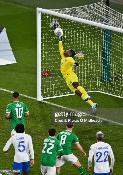 Dublin , Ireland - 27 March 2023; France goalkeeper Mike Maignan saves the header from Nathan Collins of Republic of Ireland during the UEFA EURO...